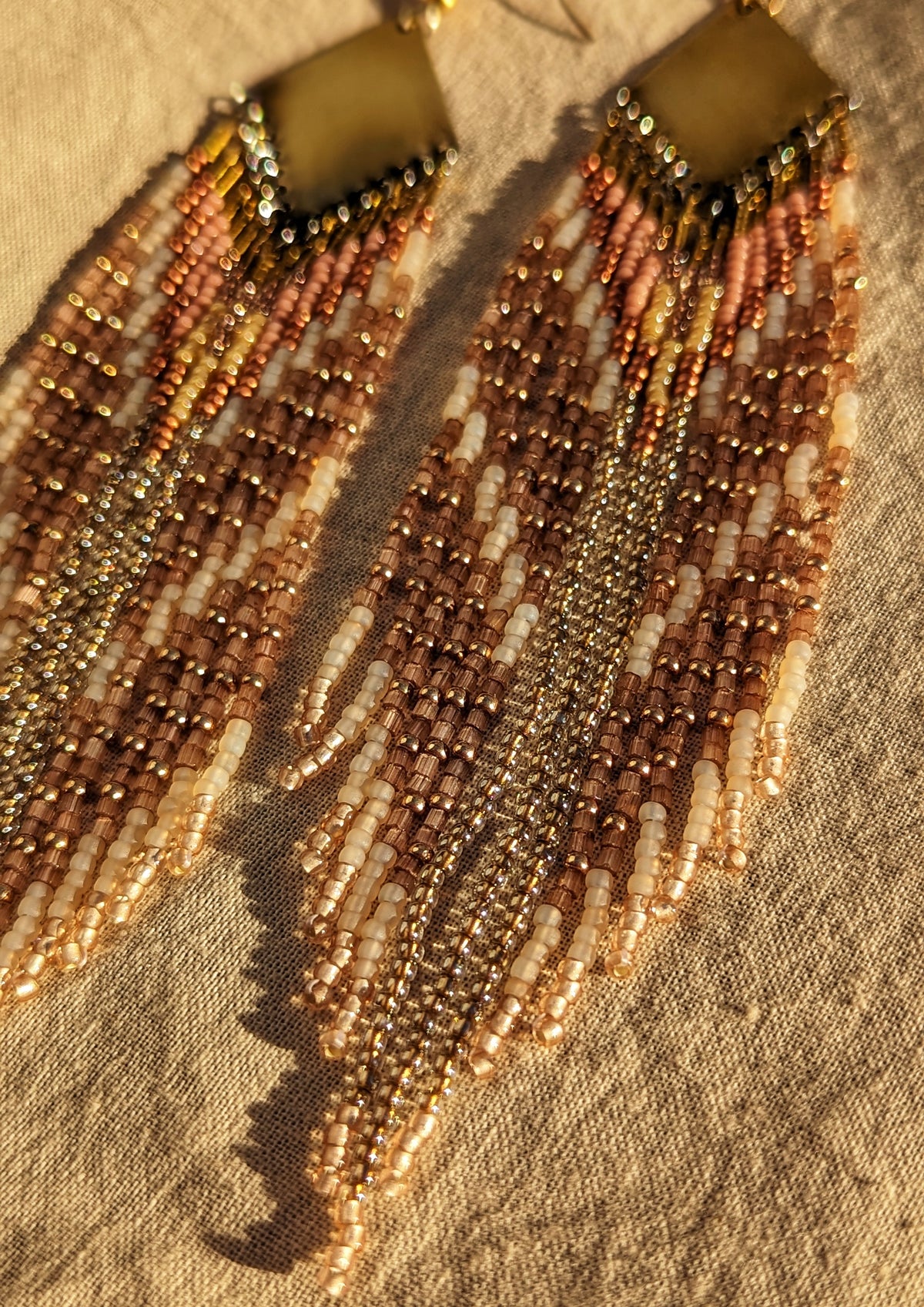 Moon & Milk blush, cream, and gold seed bead fringe earrings with a brass plate, handcrafted in a long, lightweight statement design.