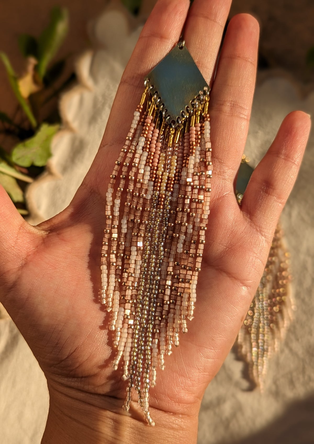 Moon & Milk blush, cream, and gold seed bead fringe earrings with a brass plate, handcrafted in a long, lightweight statement design.