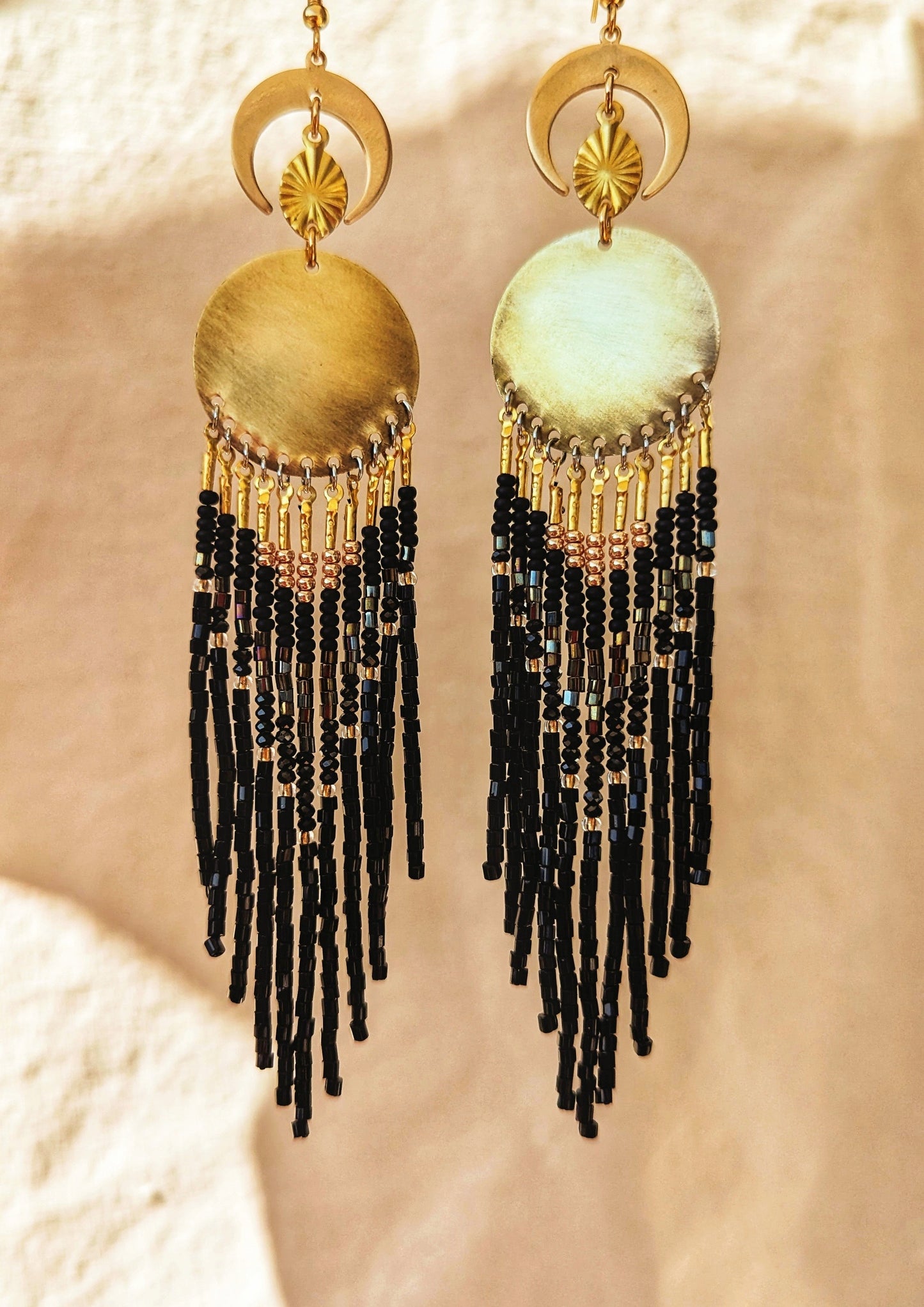 La Catrina-inspired handcrafted earrings by Moon & Milk, featuring black beads, brass accents, and a dynamic design, reflecting cultural reverence and elegance.