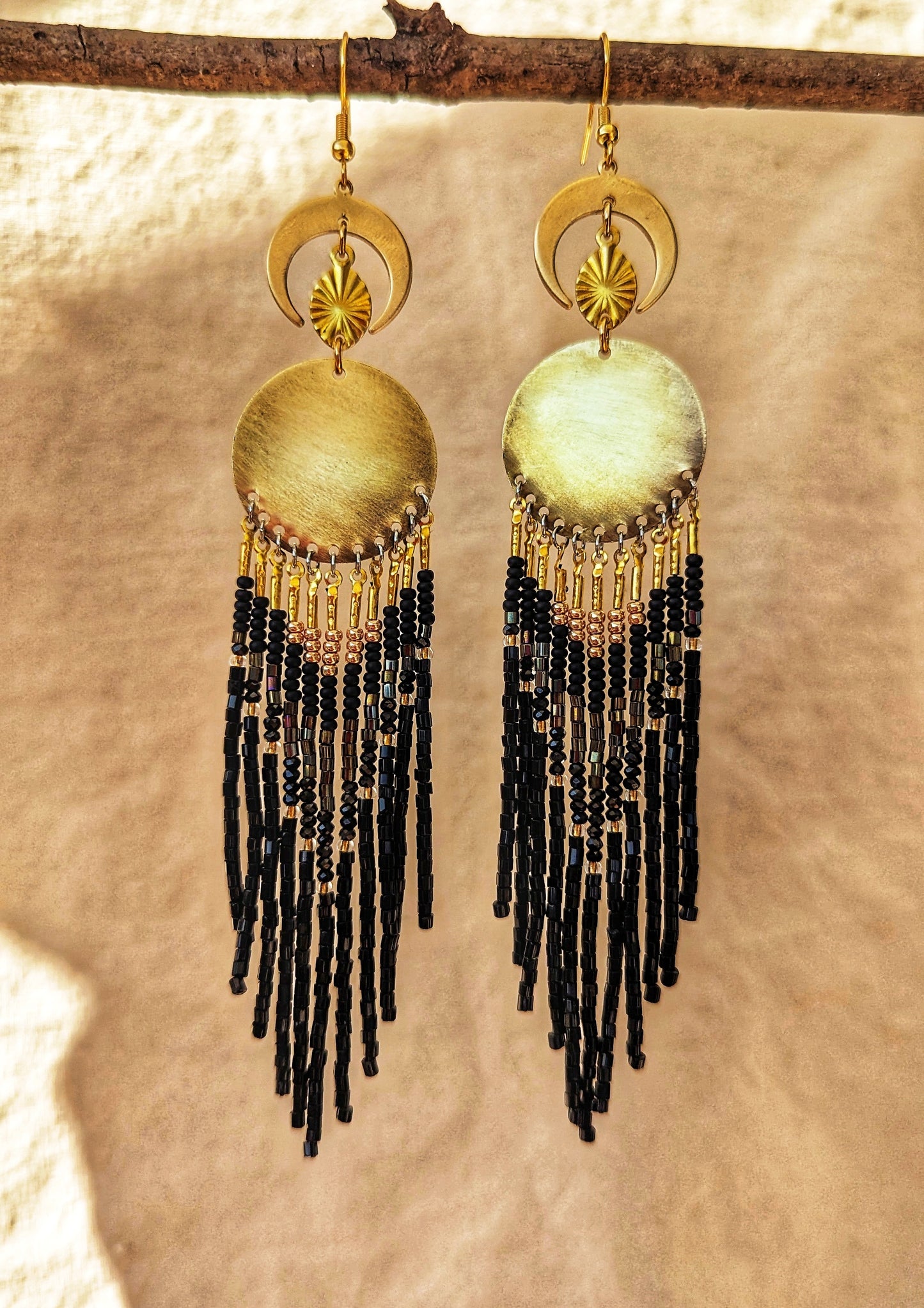 La Catrina-inspired handcrafted earrings by Moon & Milk, featuring black beads, brass accents, and a dynamic design, reflecting cultural reverence and elegance.