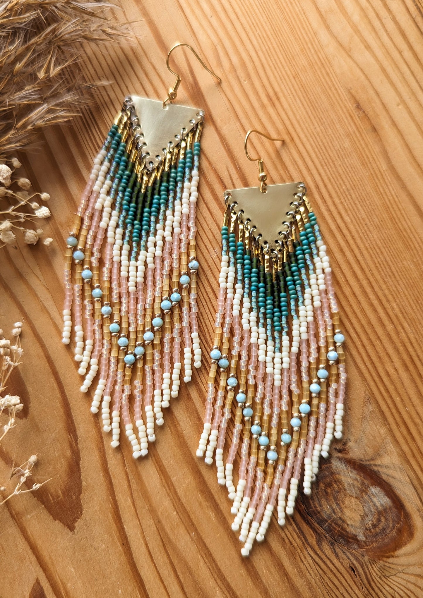 Long beaded earrings by Moon & Milk with soft pink, ivory, forest green, and sky blue larimar stones, finished with brass tops and handmade fringe design.