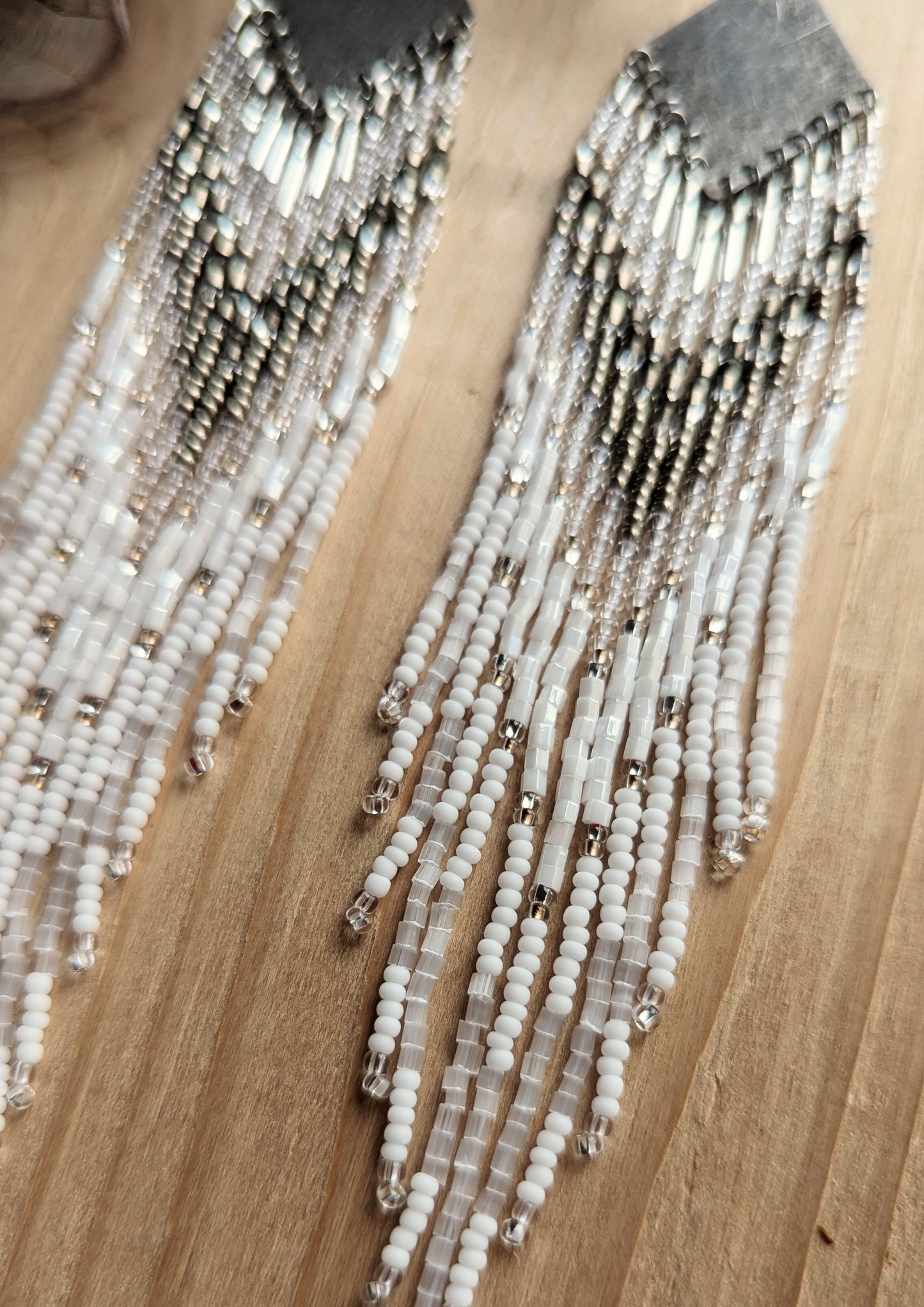 Handcrafted beaded earrings with Czech beads, silver accents, and brass, featuring a delicate white and silver design for an artisan-crafted, textured look.