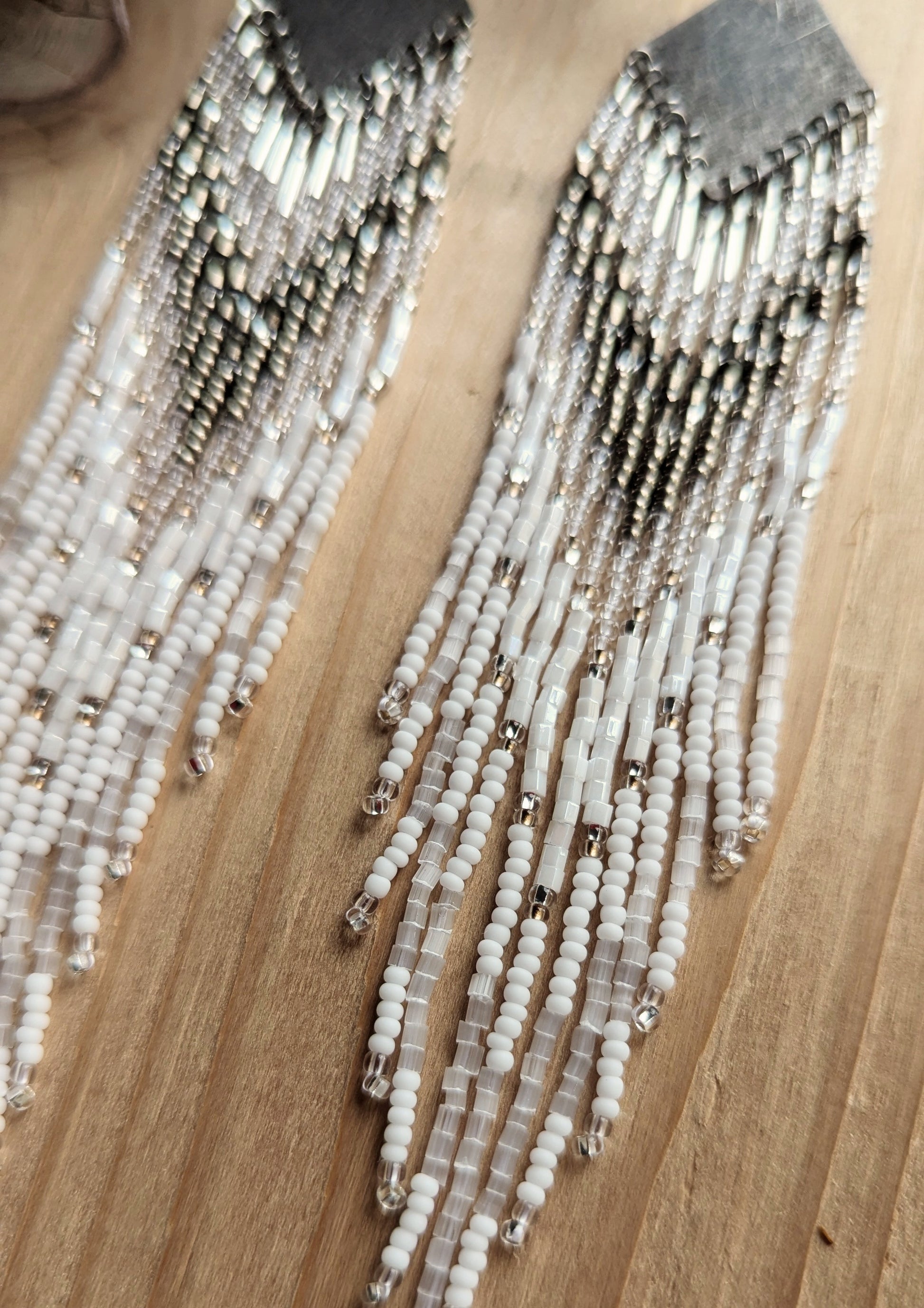 Handcrafted beaded earrings with Czech beads, silver accents, and brass, featuring a delicate white and silver design for an artisan-crafted, textured look.