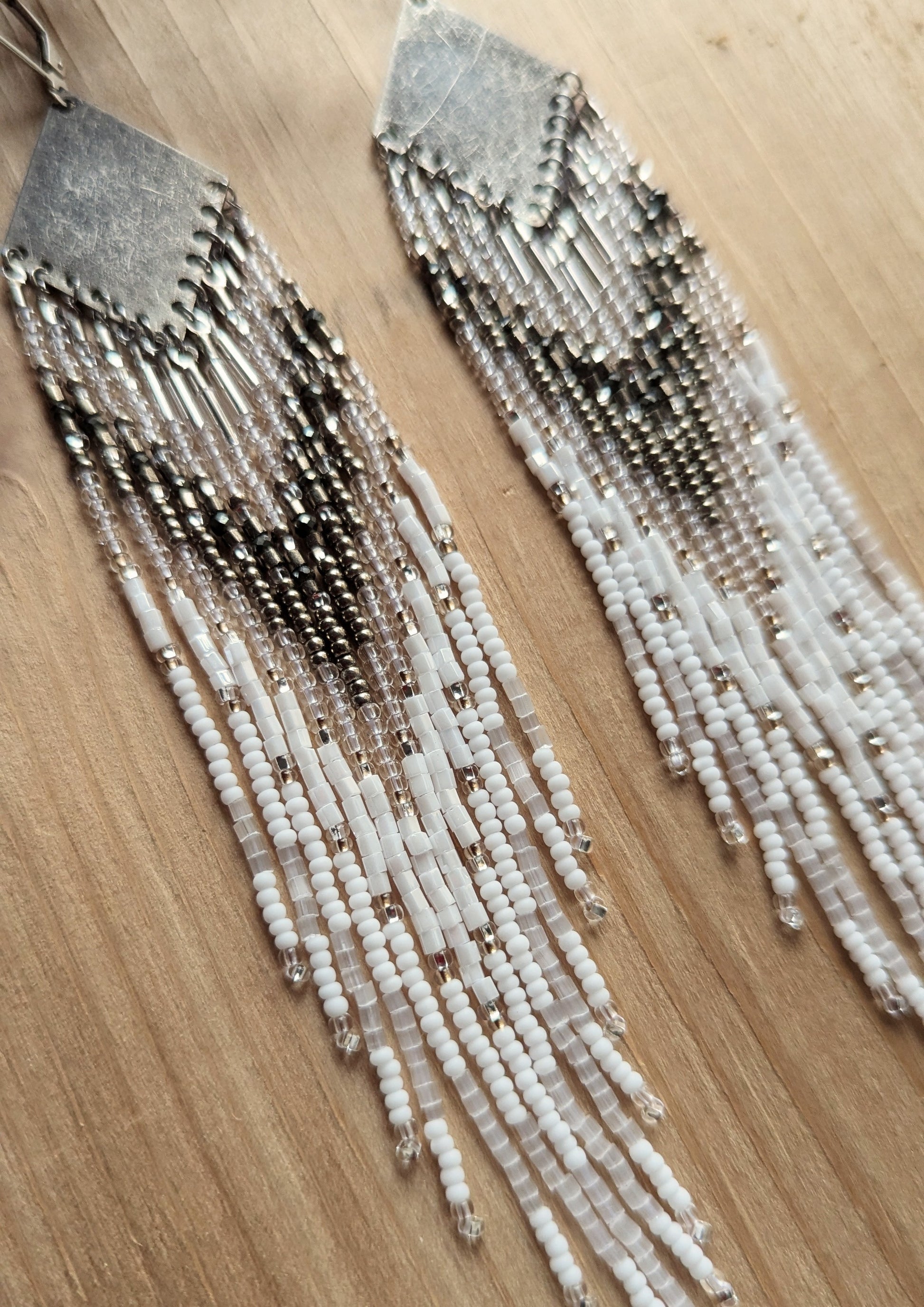 Handcrafted beaded earrings with Czech beads, silver accents, and brass, featuring a delicate white and silver design for an artisan-crafted, textured look.