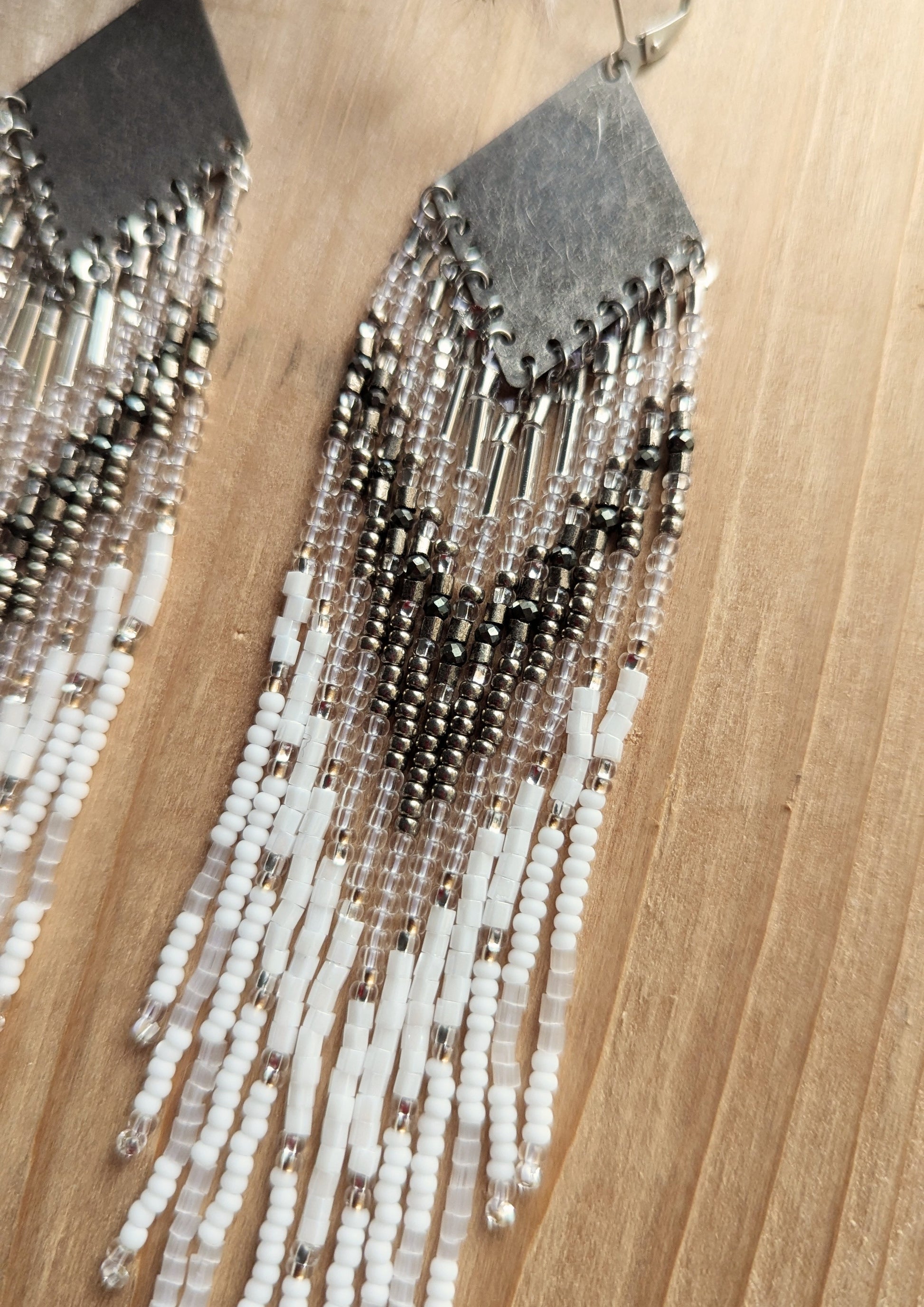 Handcrafted beaded earrings with Czech beads, silver accents, and brass, featuring a delicate white and silver design for an artisan-crafted, textured look.