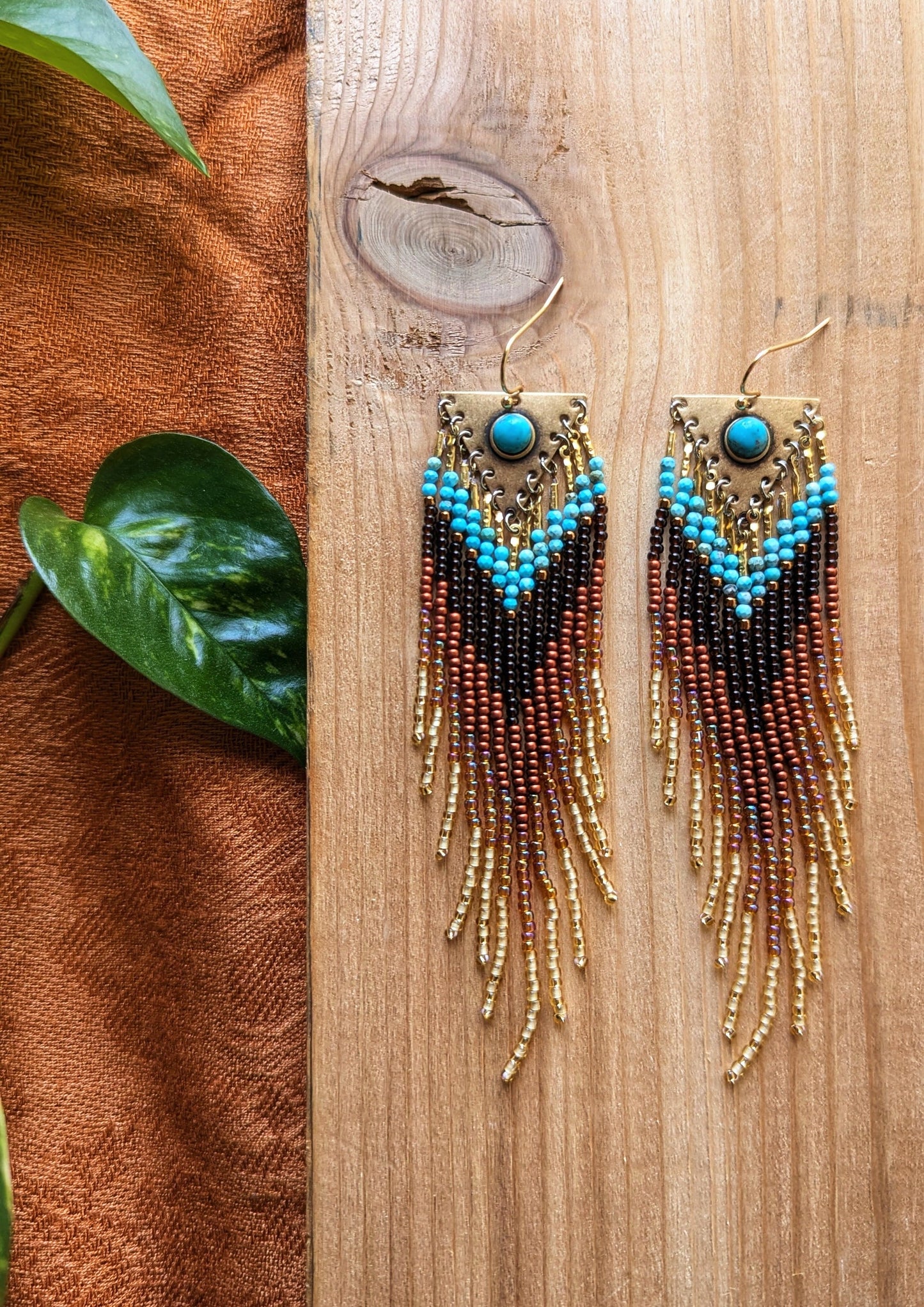 Handcrafted beaded earrings by Moon & Milk with turquoise accents, seed beads, and brass, featuring an artistic, textured design that makes a statement.