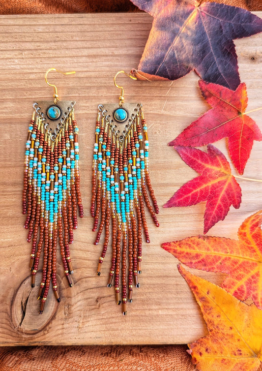 Handcrafted beaded earrings by Moon & Milk featuring turquoise accents, seed beads, and brass, with a Southwestern design full of vibrant color and texture.