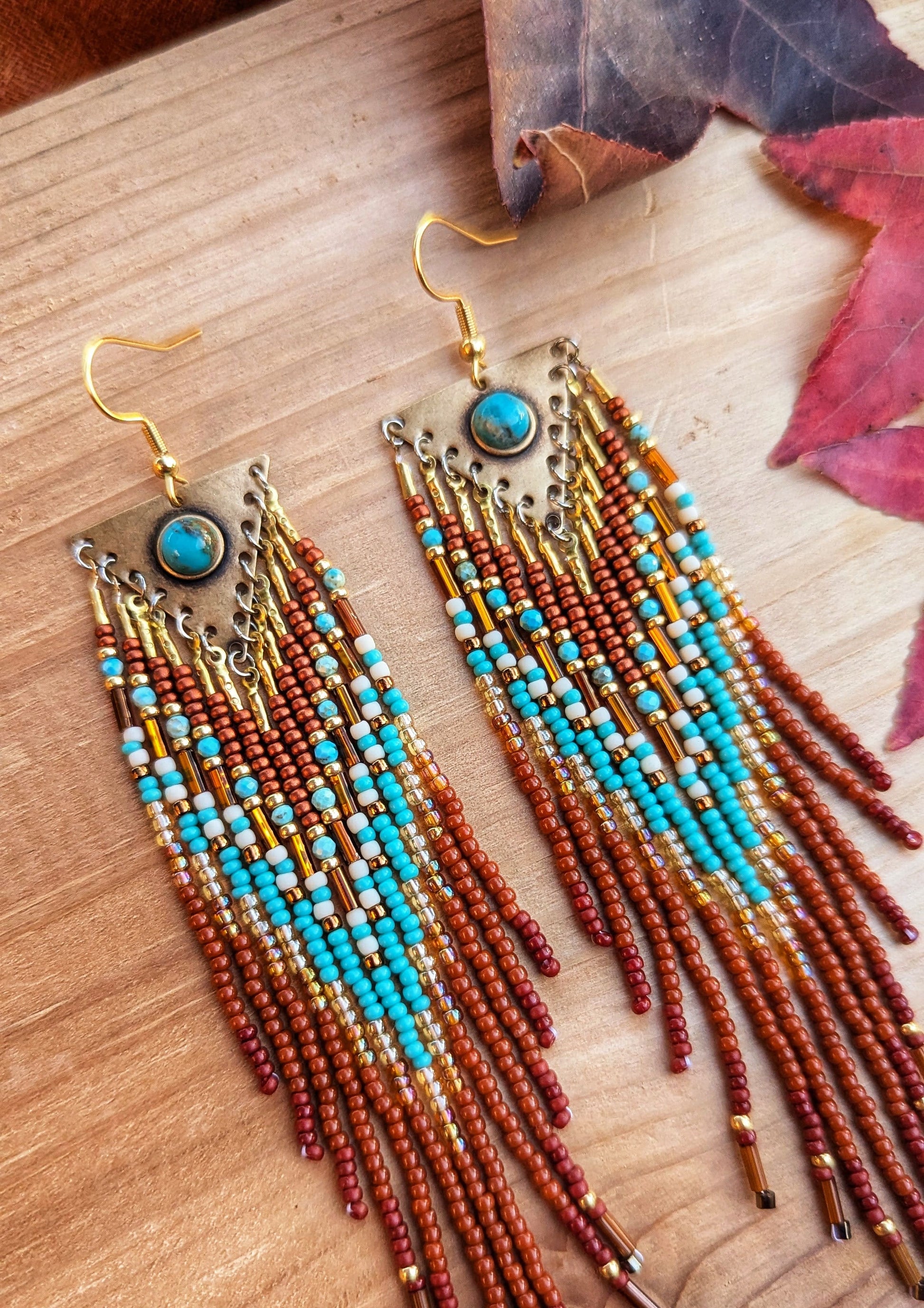 Handcrafted beaded earrings by Moon & Milk featuring turquoise accents, seed beads, and brass, with a Southwestern design full of vibrant color and texture.