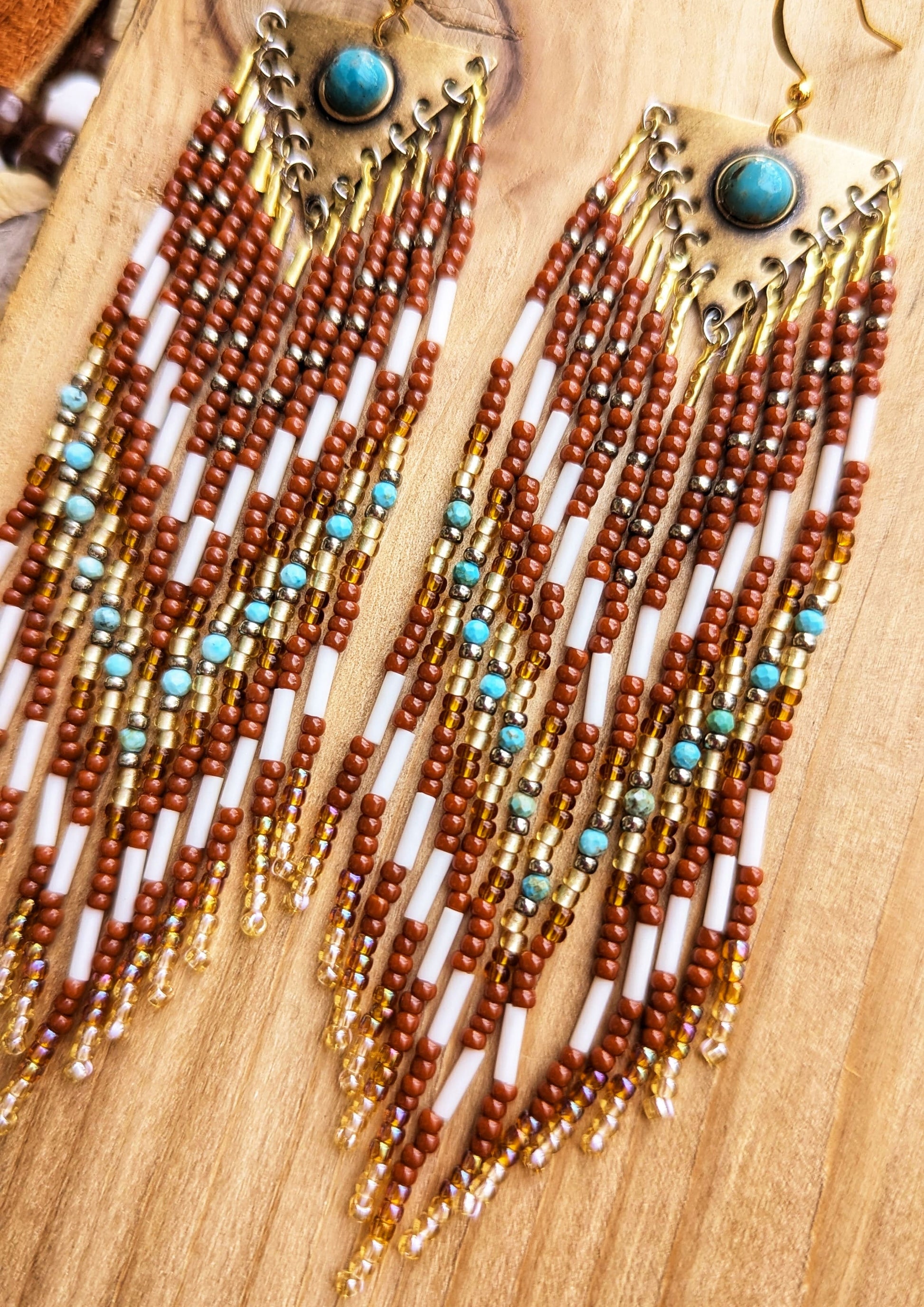 Handcrafted beaded earrings by Moon & Milk featuring turquoise accents, glass beads, and brass, with intricate beadwork and a stunning Southwestern design.