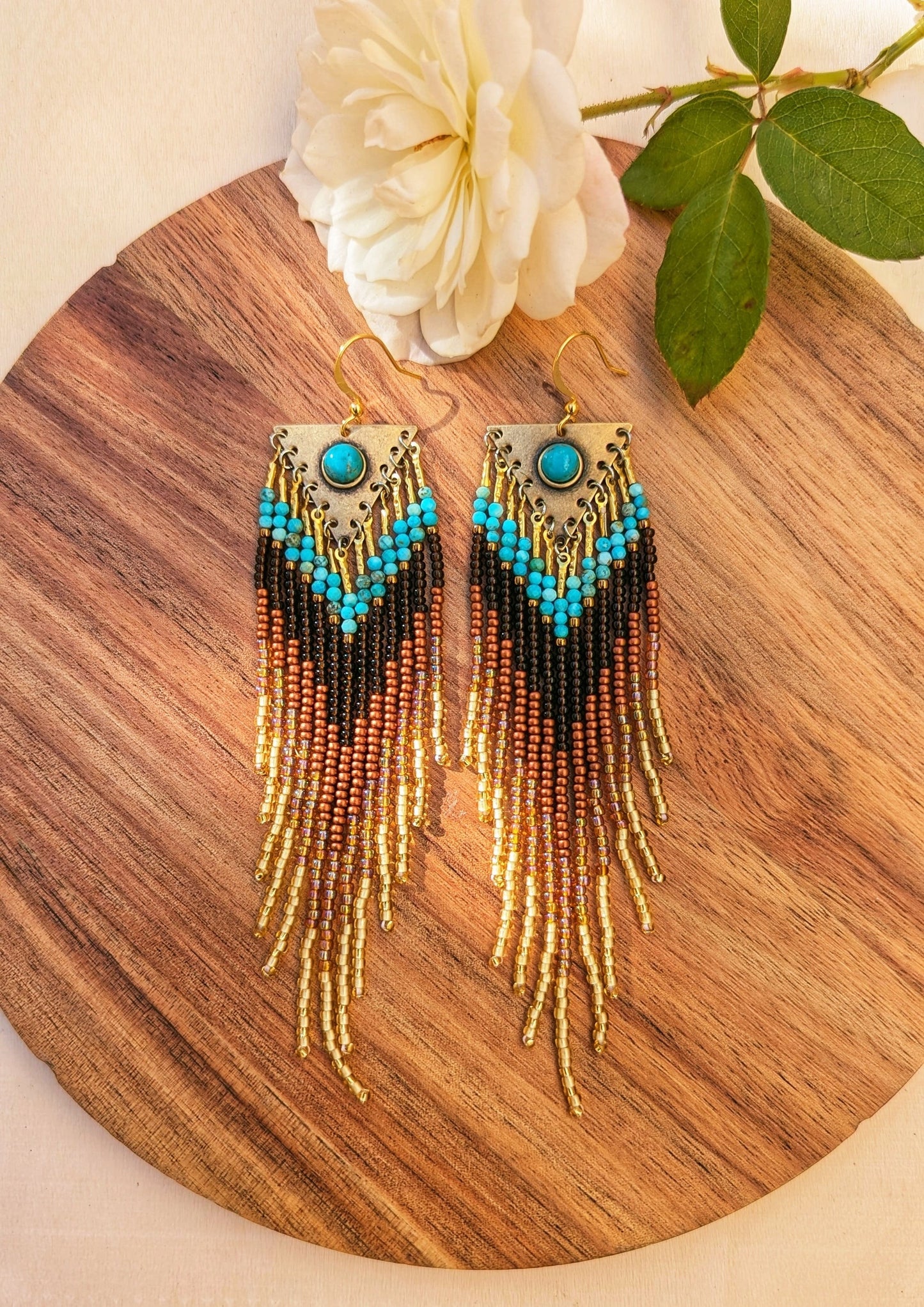 Handcrafted beaded earrings by Moon & Milk with turquoise accents, seed beads, and brass, featuring an artistic, textured design that makes a statement.