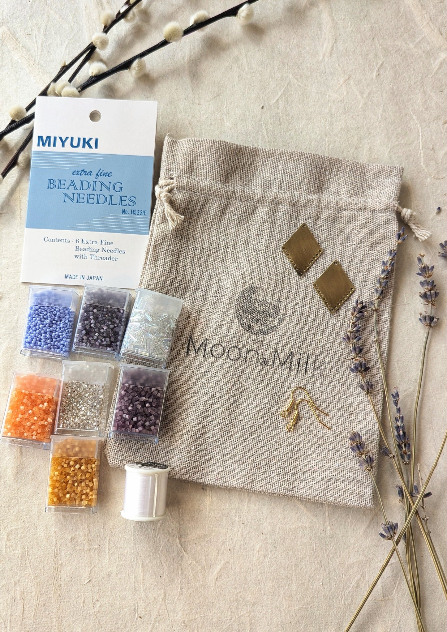 Moon & Milk Beading Kit with beads, Miyuki extra fine beading needles, thread, brass findings, and a storage pouch for creating handmade beaded earrings.