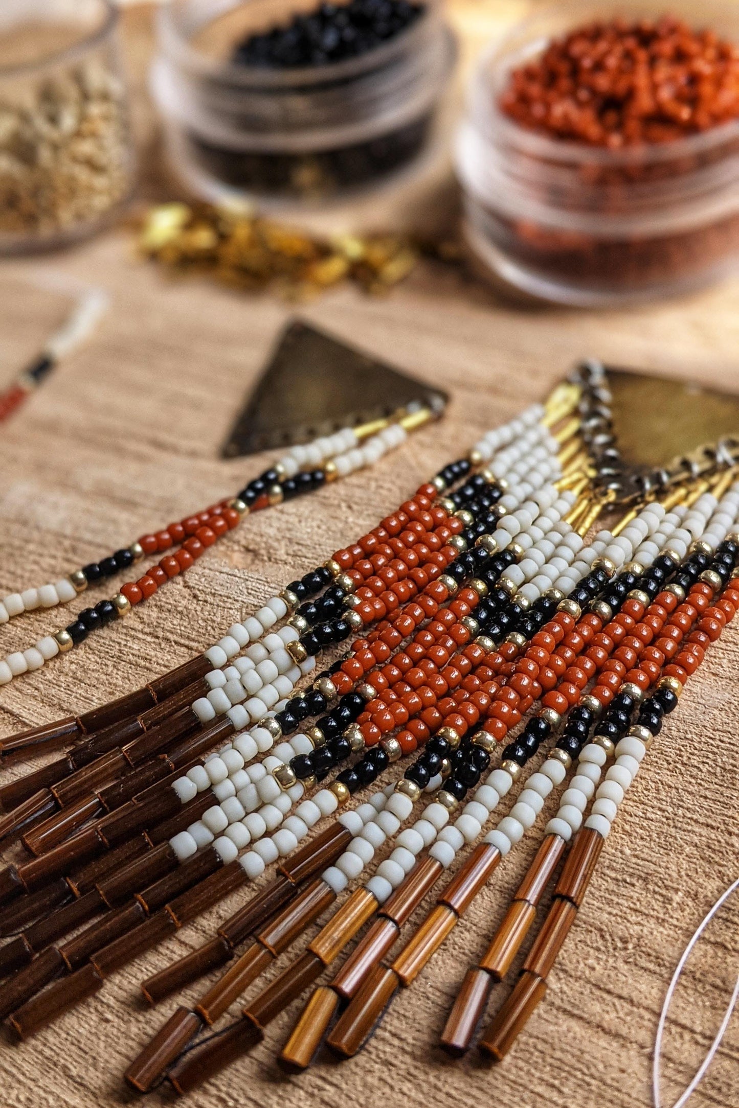 Terracotta seed bead earrings with brown fringes and a chevron design. -Moon & Milk