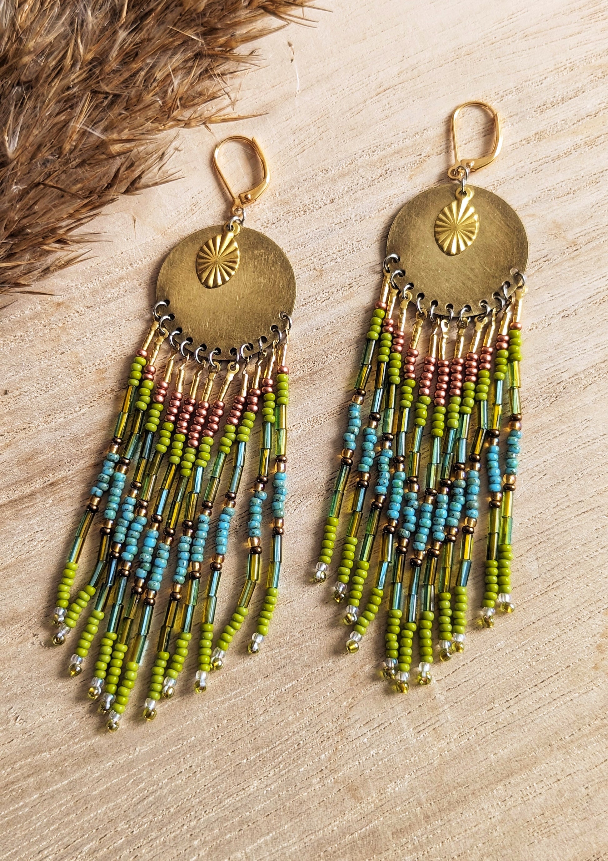 Moon & Milk handcrafted earrings with brass medallion, lime green, copper, and turquoise beaded fringe, inspired by the colors of the rainforest.