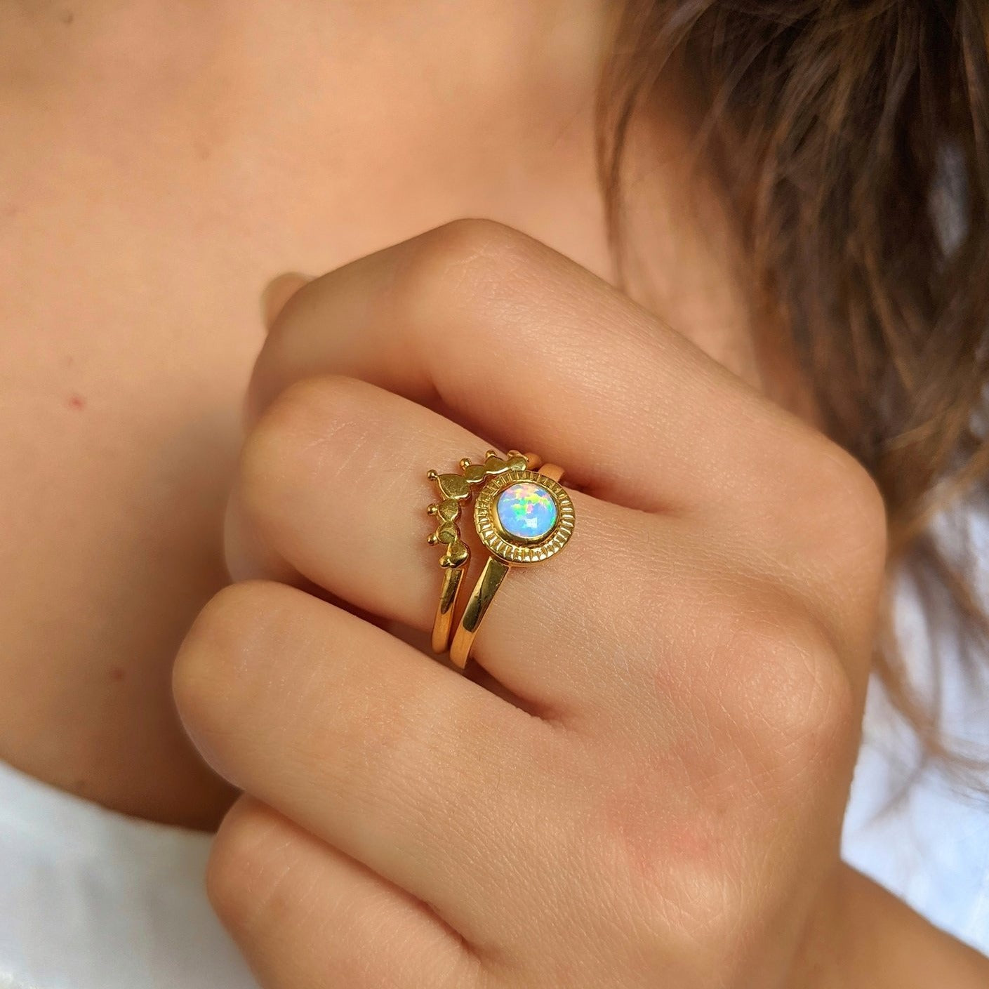 14k gold plated sterling silver opal ring set with crown stacking band, shown on hand for scale and detail of iridescent gemstone and artistic design.