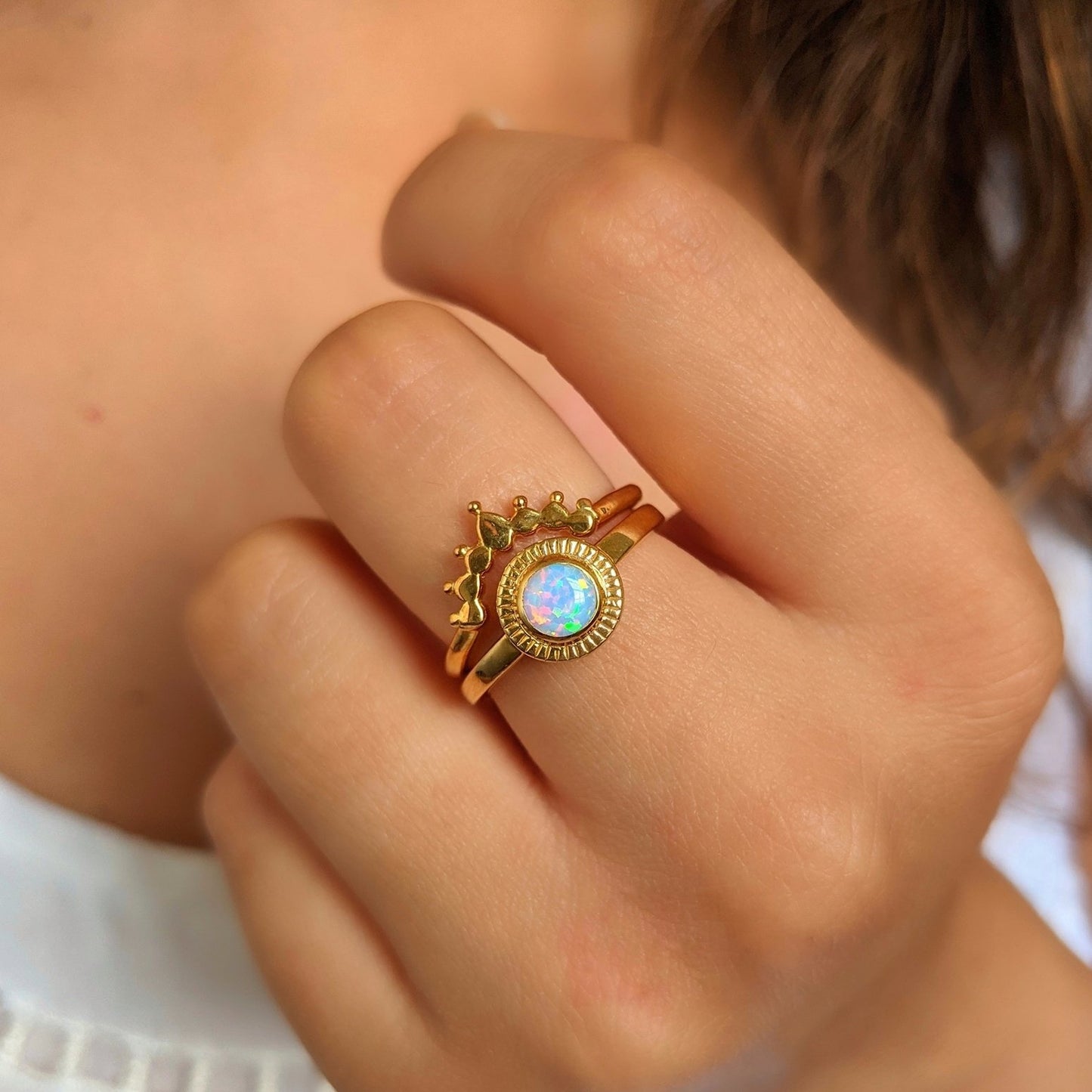 14k gold plated sterling silver opal ring set with crown stacking band, shown on hand for scale and detail of iridescent gemstone and artistic design.