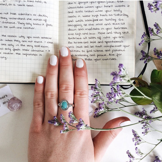 Sterling silver boho turquoise ring with a twisted rope outline.