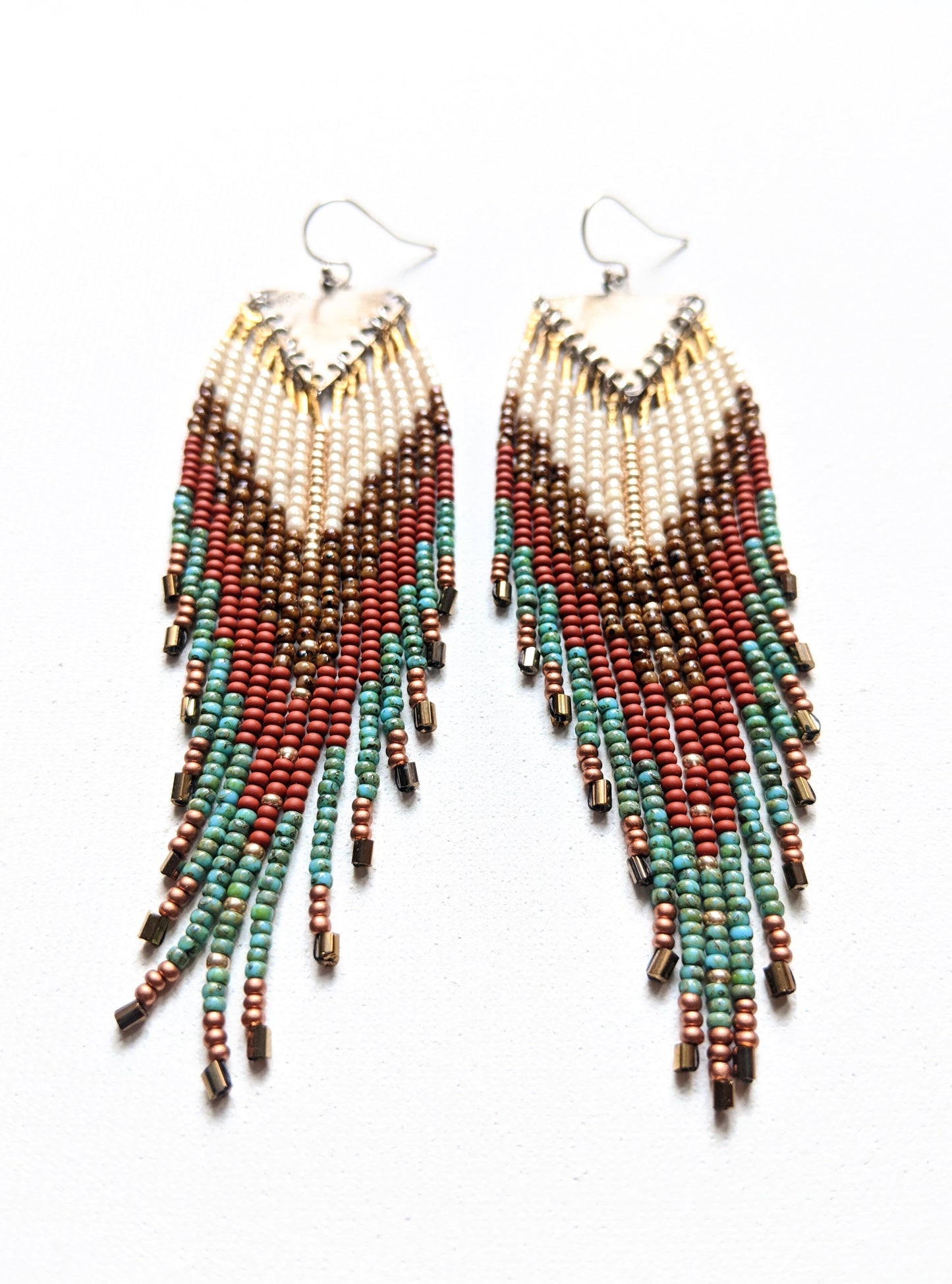 Moon & Milk - Handmade beaded earrings featuring a mix of ivory, brown, terracotta, and turquoise beads with a vintage brass chevron pendant, perfect for boho-chic and Southwestern-inspired fashion.