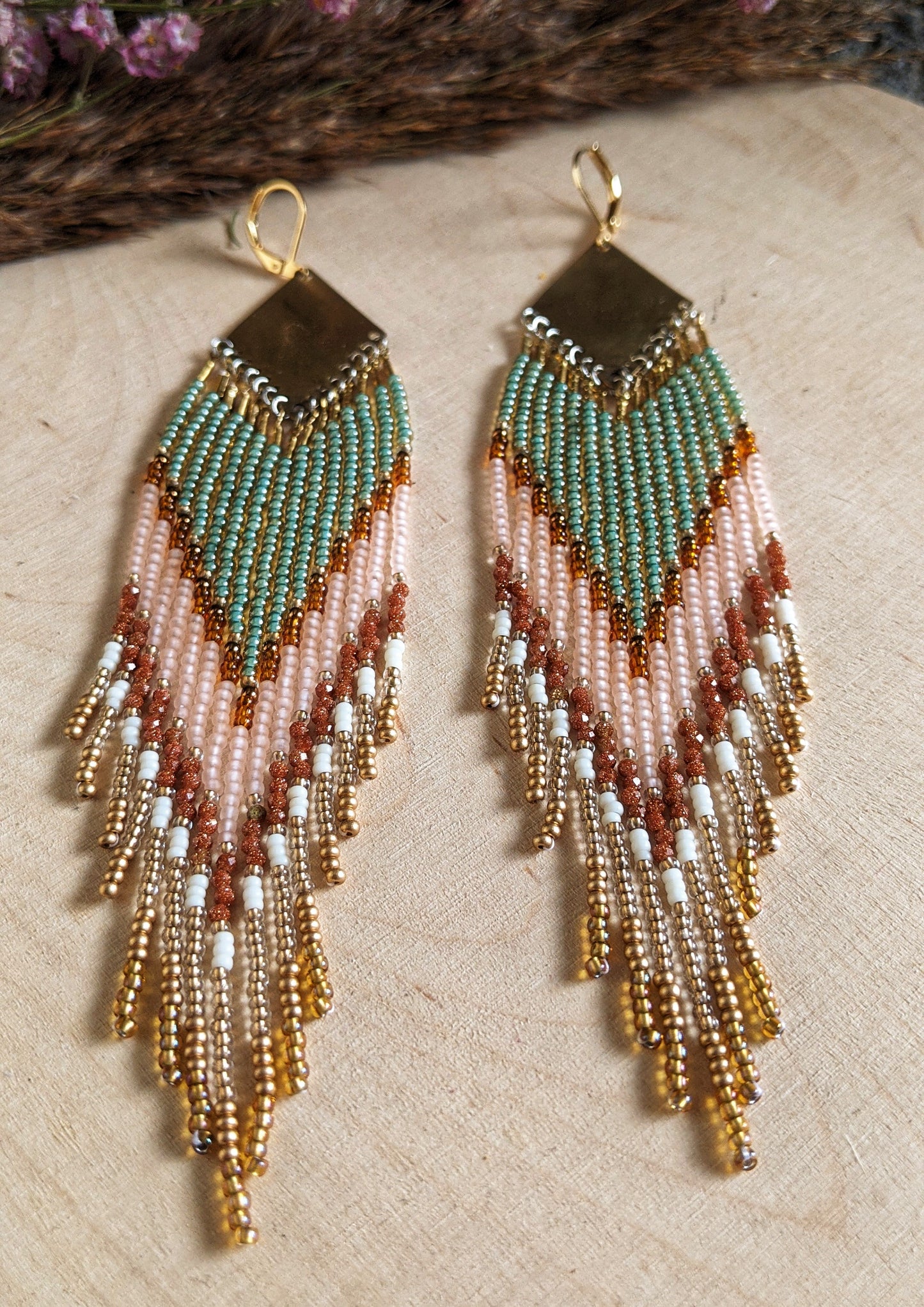 Handcrafted beaded earrings made with Czech beads, brass, and sandstone in green, pink, and gold for a beautiful, boho design.