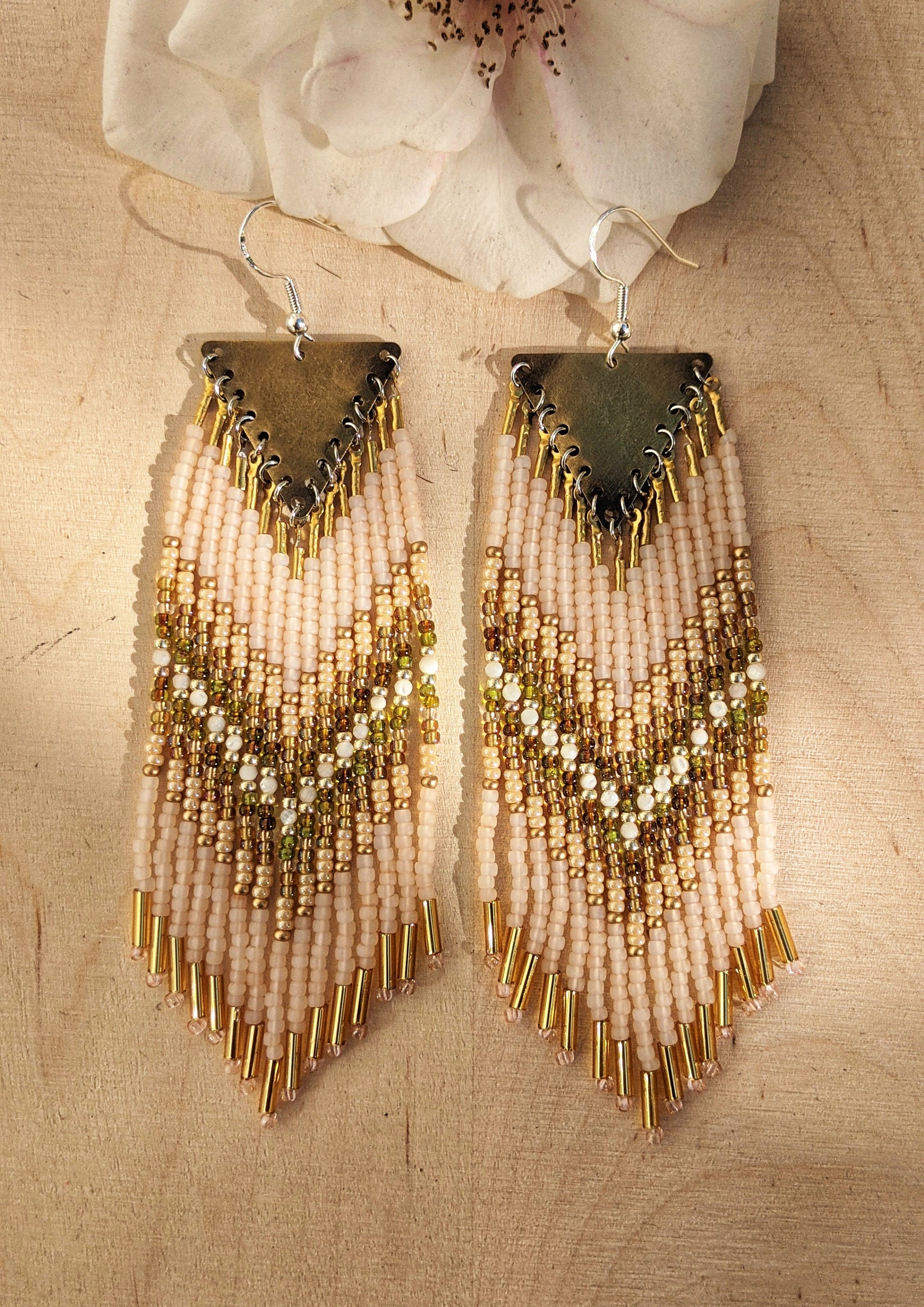 Moon & Milk handmade beaded earrings with cream, gold, olive, Mother of Pearl, and white beadwork in a chevron pattern, finished with brass findings and soft pink tips.