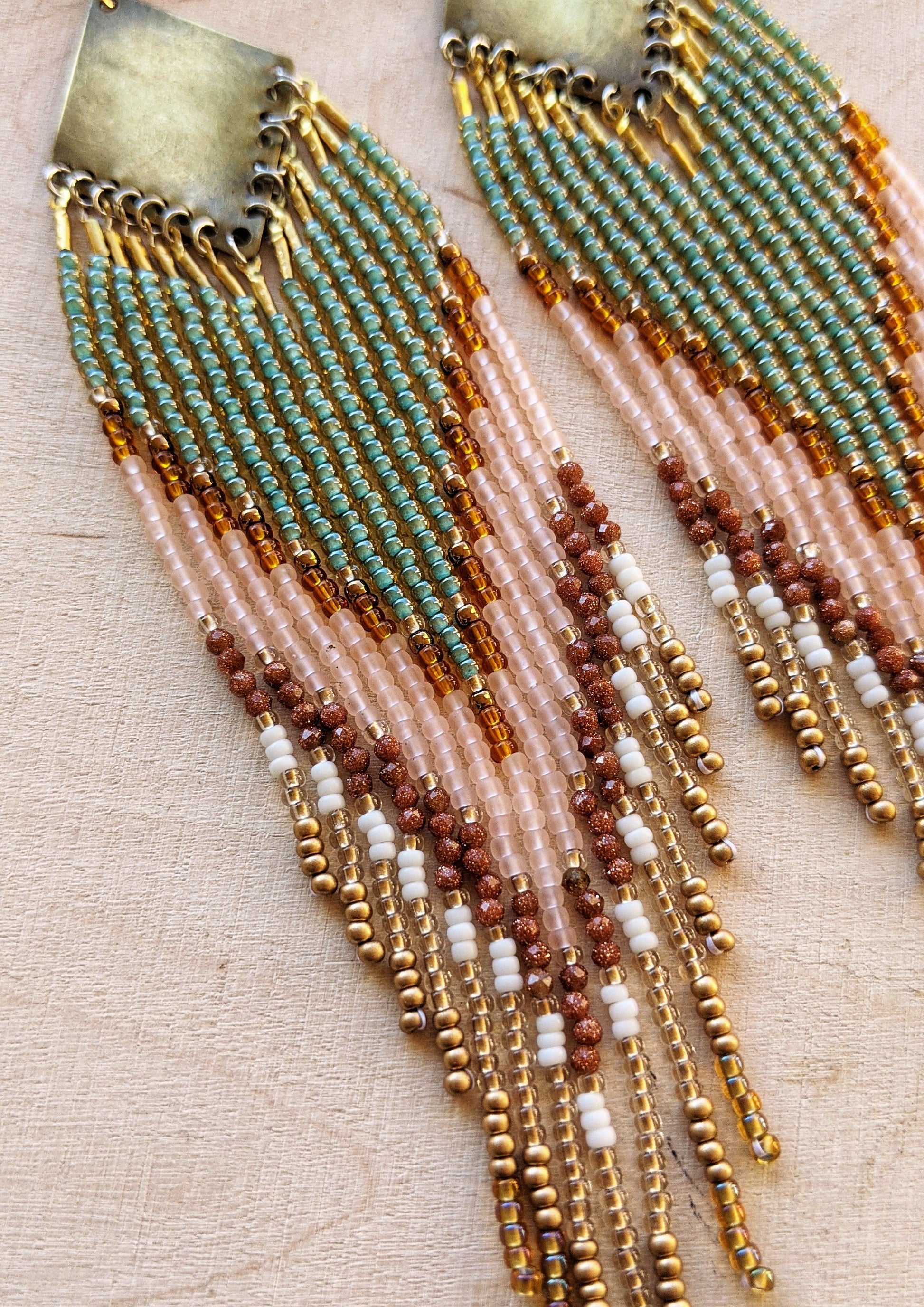 Handcrafted beaded earrings made with Czech beads, brass, and sandstone in green, pink, and gold for a beautiful, boho design.