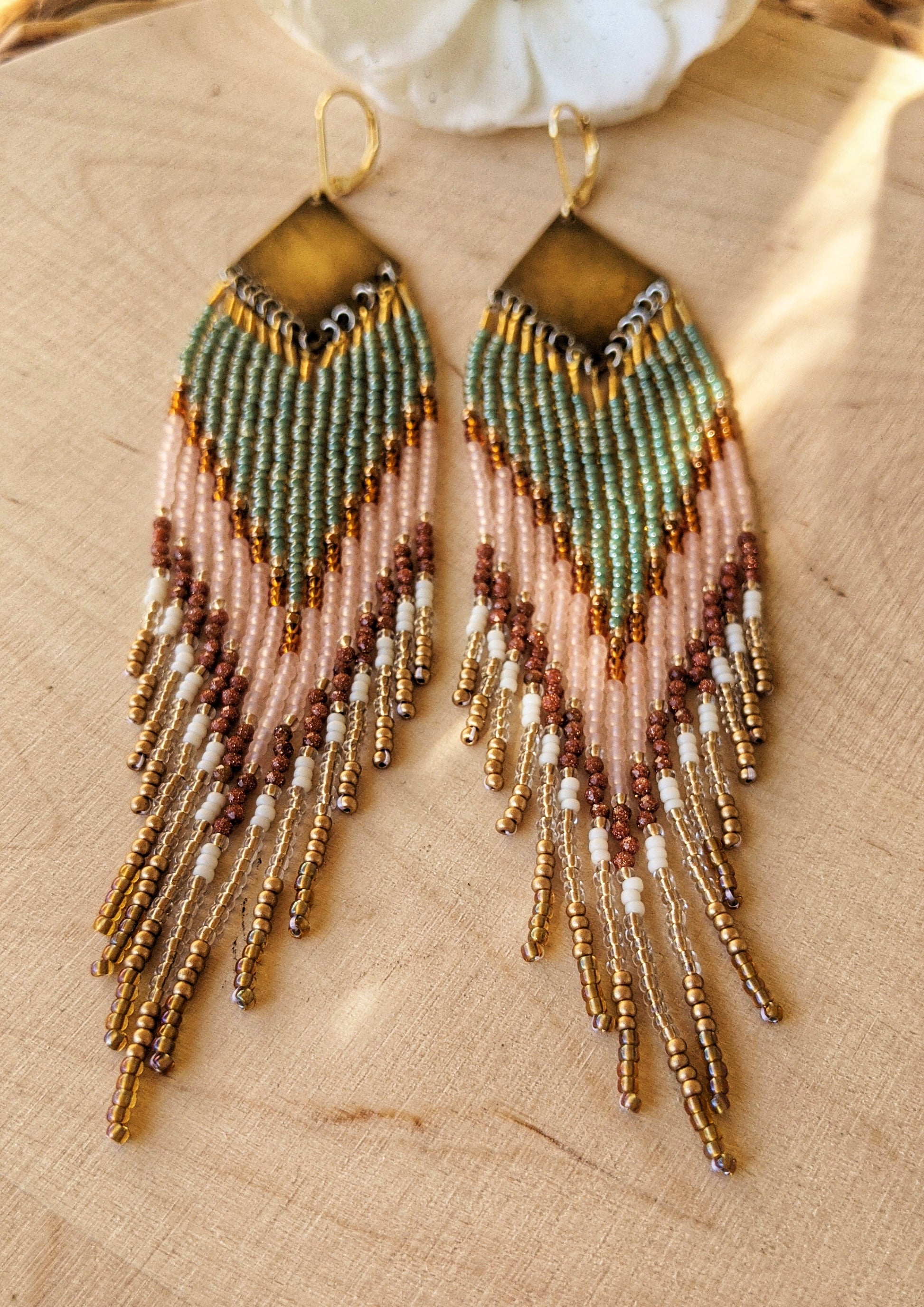 Handcrafted beaded earrings made with Czech beads, brass, and sandstone in green, pink, and gold for a beautiful, boho design.
