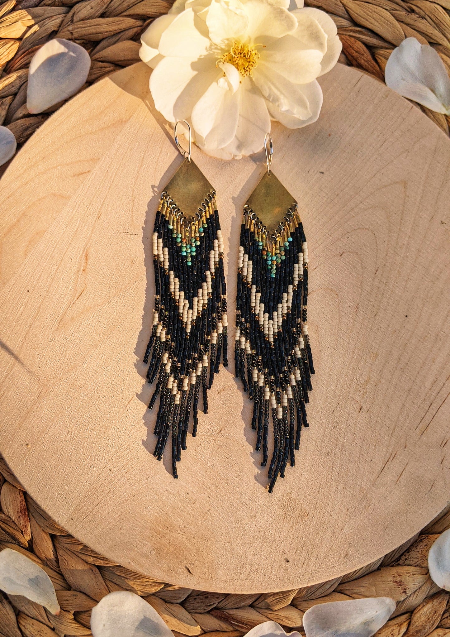 Long native beaded earrings in black, cream, and turquoise stones with brass tops, handcrafted for lovers of artisan jewelry and wearable art by Moon & Milk.