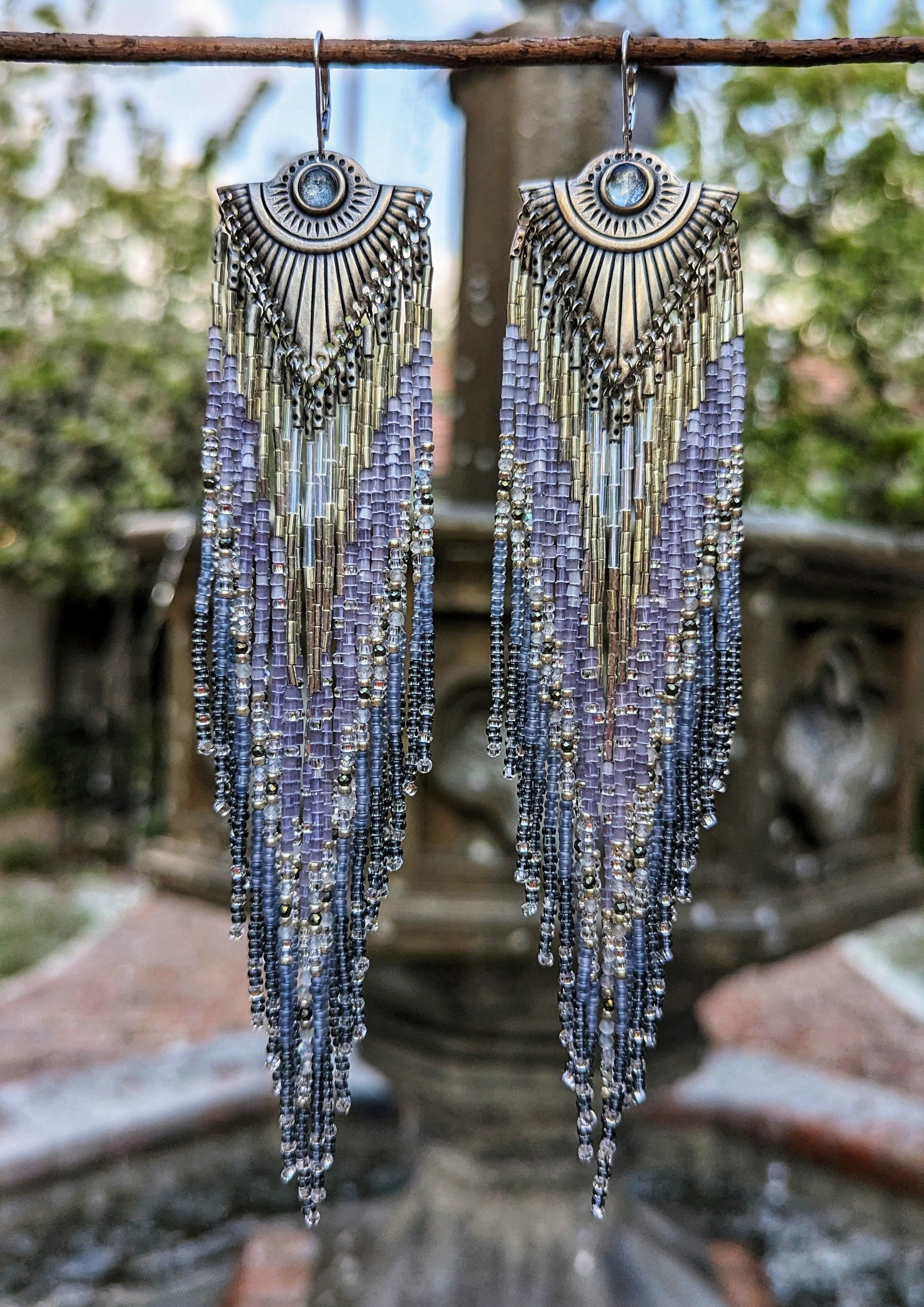 Handcrafted beaded earrings by Moon & Milk inspired by Tlaloc, featuring silver hues, labradorite, pyrite stones, topaz cabochons, and sterling silver leverbacks.