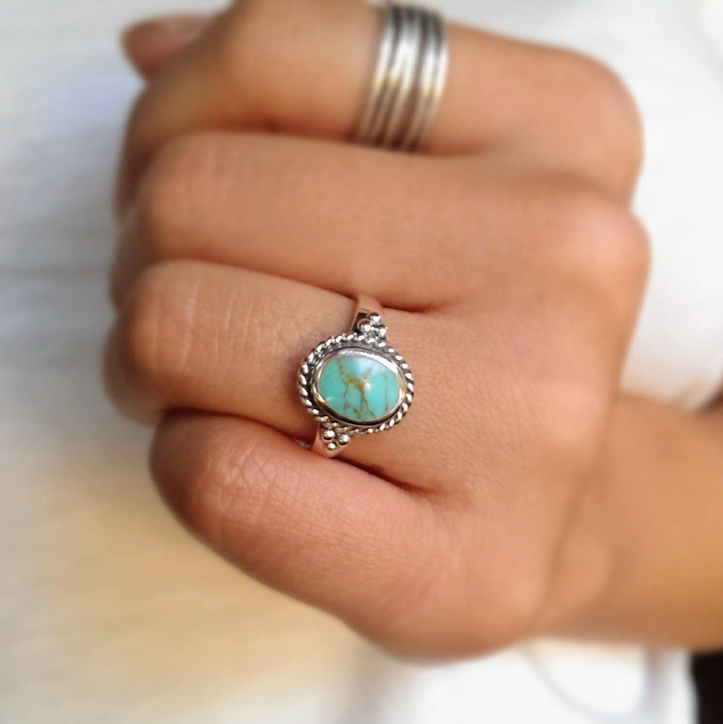 Sterling silver boho turquoise ring with a twisted rope outline.