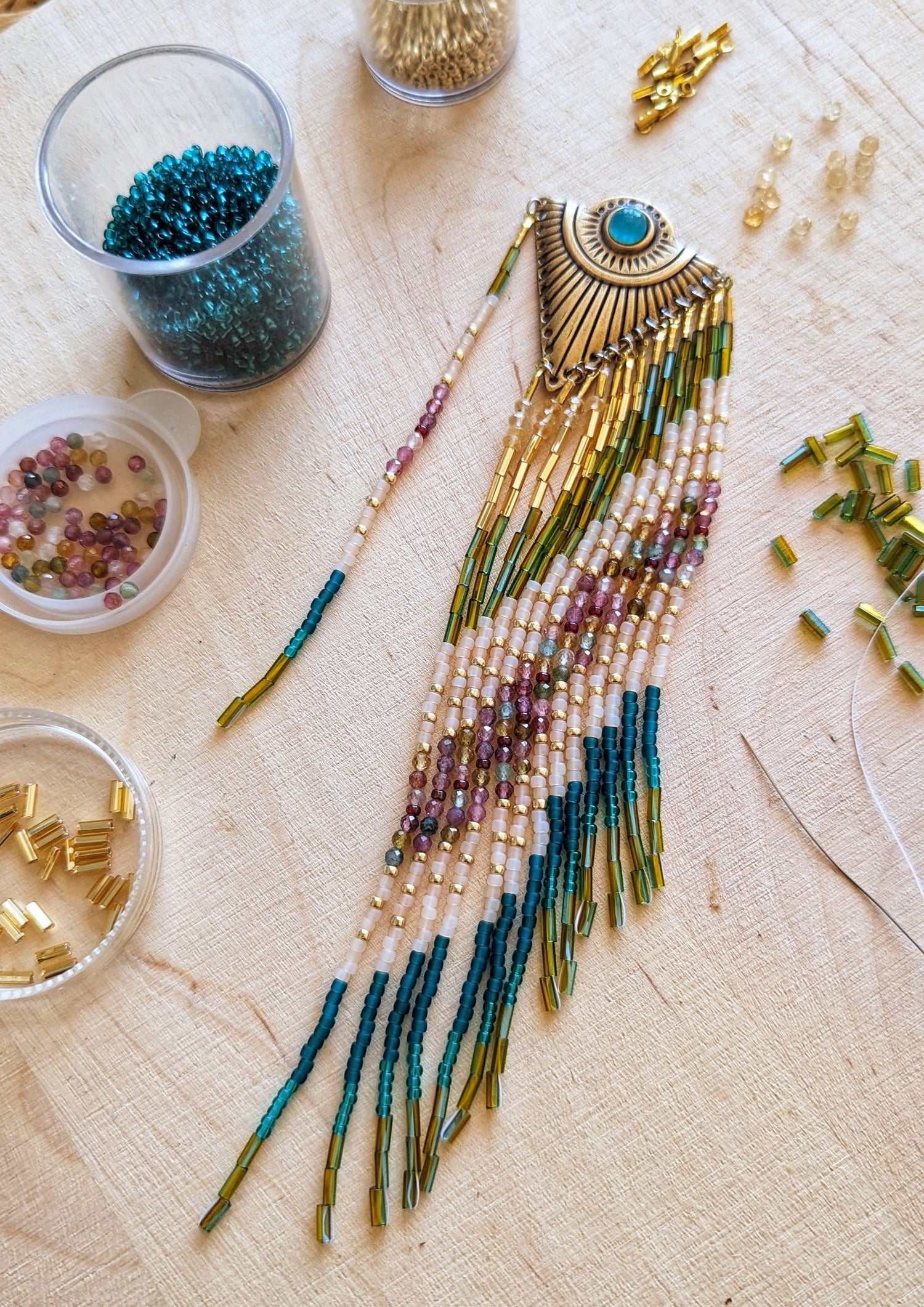 Four pairs of handcrafted beaded earrings featuring vibrant colors, brass accents, and unique designs. Moon & Milk logo visible, perfect for boho, artistic looks.