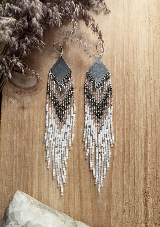 Handcrafted beaded earrings with Czech beads, silver accents, and brass, featuring a delicate white and silver design for an artisan-crafted, textured look.