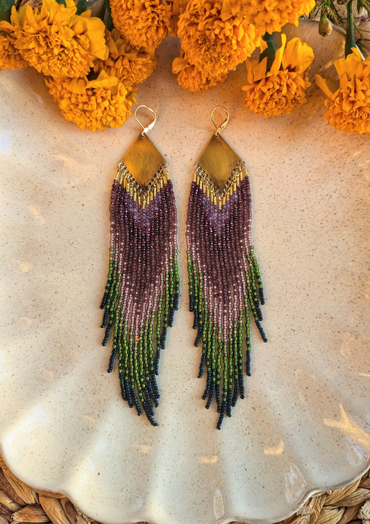 Moon & Milk handcrafted beaded earrings with purple, green, and navy glass beads, brass tops, and long fringe, designed as artisan wearable art.