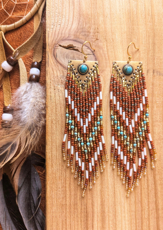 Handcrafted beaded earrings by Moon & Milk featuring turquoise accents, glass beads, and brass, with intricate beadwork and a stunning Southwestern design.