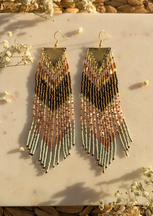 Handcrafted beaded fringe earrings with a chevron pattern in gold, bronze, and mint green, accented by delicate fringe and shimmering details.