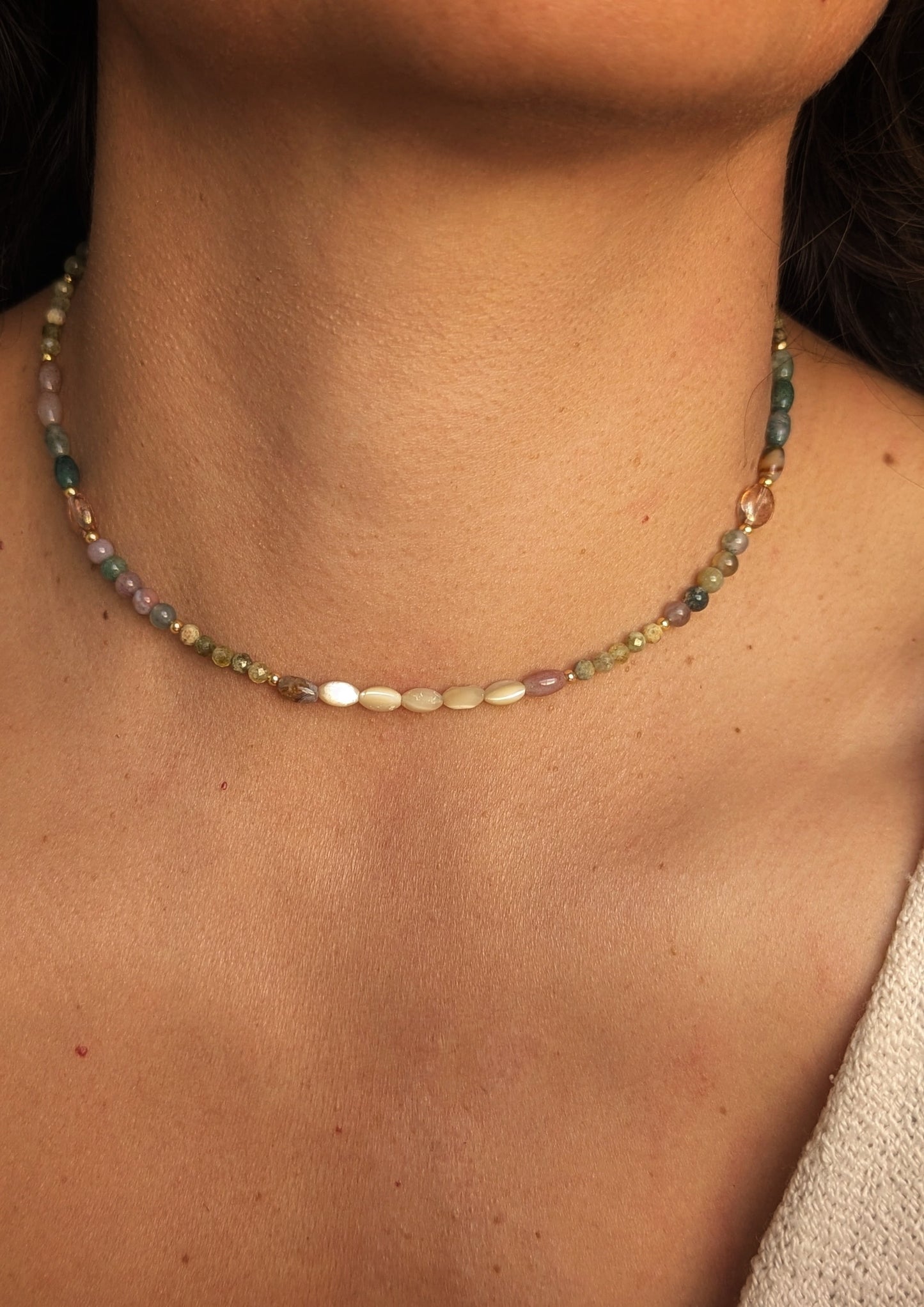 Necklace with Indian agate multicolored gemstone beads worn by a woman.