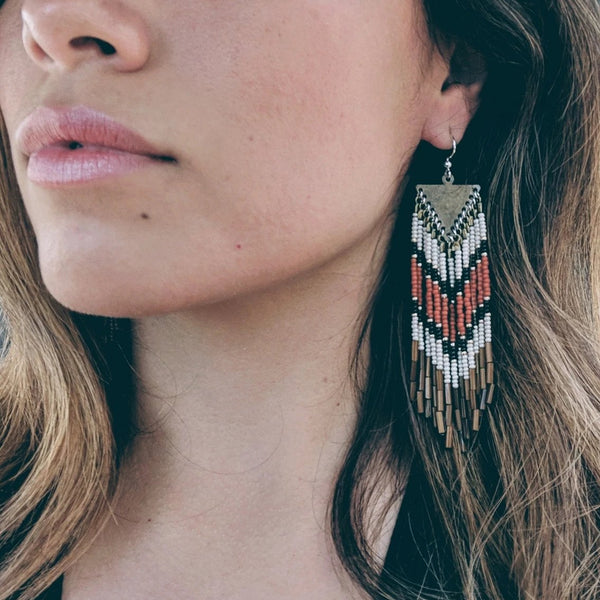 Moon & Milk- Orange and gold bohemian earrings with brown fringes and a chevron design. 