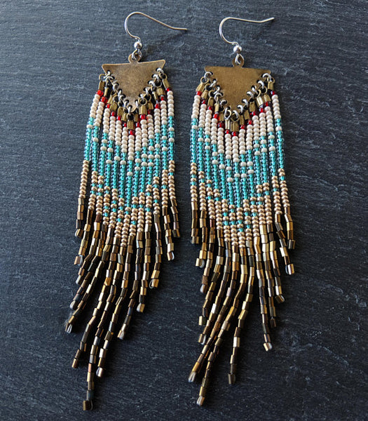 Moon & Milk - Handcrafted long native beaded earrings with 5 different layers of colors: red, pearl white, aqua, gold, and iris bronze. Created with glass beads, antique brass, and sterling silver