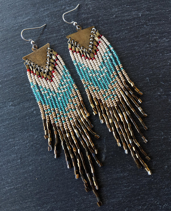 Moon & Milk - Handcrafted long native beaded earrings with 5 different layers of colors: red, pearl white, aqua, gold, and iris bronze. Created with glass beads, antique brass, and sterling silver
