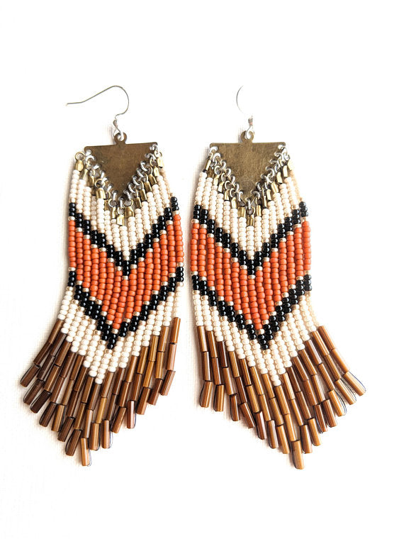 Moon & Milk- Orange and gold bohemian earrings with brown fringes and a chevron design. 