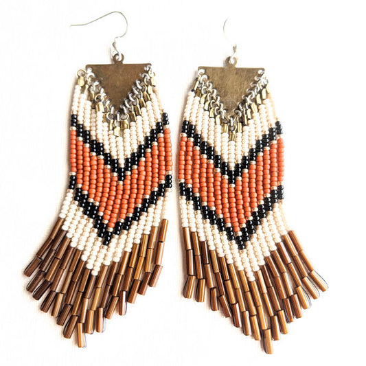 Moon & Milk- Orange and gold bohemian earrings with brown fringes and a chevron design. 