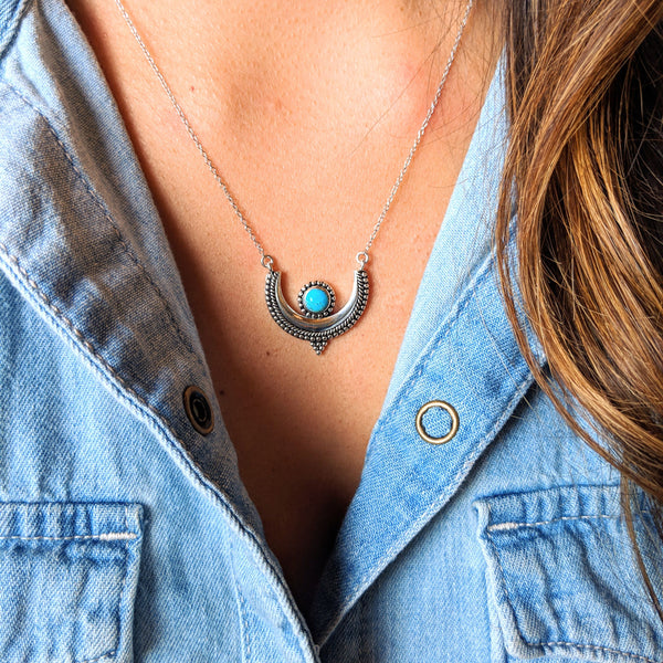 Moon & Milk - A crescent moon pendant necklace with a natural turquoise stone bezel setting and a silver chain